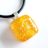 Square orange dichroic glass pendant with sterling silver bail and black cord necklace