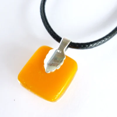 Back of orange dichroic glass pendant with sterling silver bail