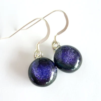 Purple dichroic glass earrings with round cabochons. Sterling silver ear hooks attached.