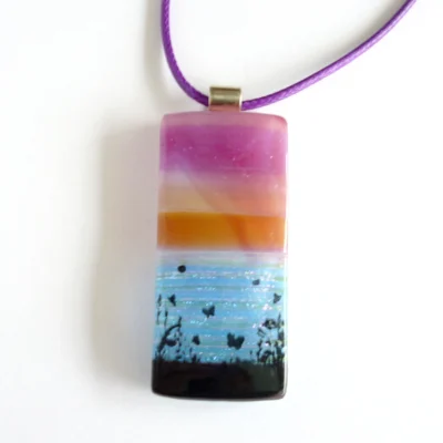 Front view of pink purple seascape pendant with sterling silver bail and purple cord necklace.
