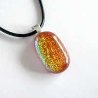 Red fused dichroic glass pendant, different angles different colours