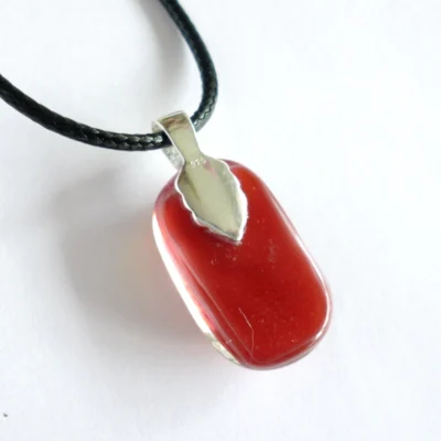 Back of handmade red dichroic glass pendant with sterling silver bail