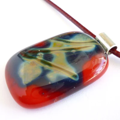 Red reactive glass pendant showing depth of glass