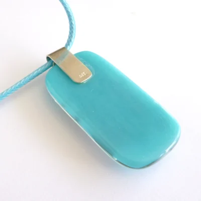 Back of turquoise blue fused reactive glass pendant with bail