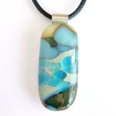 Blue pendant with sterling silver bail on a white background