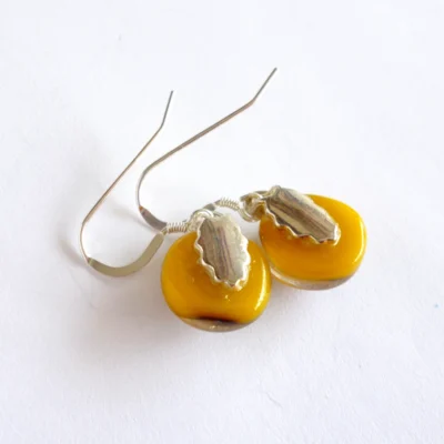 Back of yellow reactive glass earrings with silver plated bails and sterling silver ear wires attached.