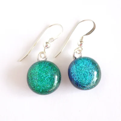 Green fused dichroic glass earrings with round cabochons. Silver plated bails and sterling silver ear wires.