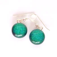 Handmade green dichroic glass earrings with round cabochons attached to silver plated bails and 925 sterling silver ear wires.