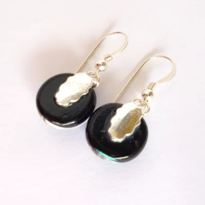 Back of handmade dichroic glass earrings with silver plated bails and sterling silver ear wires.