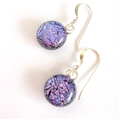 Dichroic glass earrings with pink crackle effect cabochons. Round cabochons have silver plated bails attached and dangle from 925 sterling silver ear wires.
