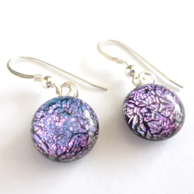 Dichroic glass earrings with round pink cabochons dangling from sterling silver ear wires. Dichroic glass cabochons have a crackle effect on top and smooth finish.