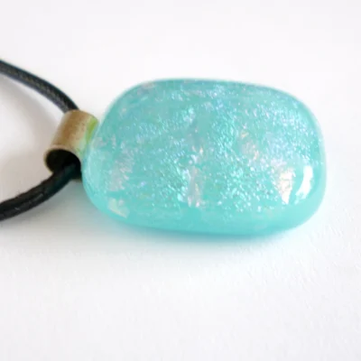 Side view of pendant showing depth of glass with a domed shape on top.