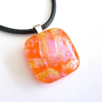 Handmade square orange dichroic glass pendant with shimmers of yellow and pink, 925 sterling silver bail and black cord necklace attached.
