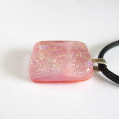 Side view of pink pendant showing layers of glass.