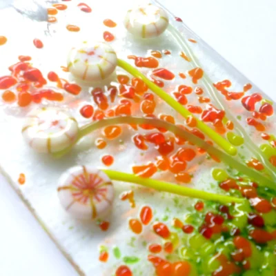 Close up of cream glass flower suncatcher showing tactile, colour and depth of glass.