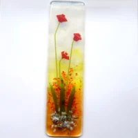 Long handmade fused glass suncatcher featuring vibrant tactile red flowers with green stems against a white, green, orange, and red background.