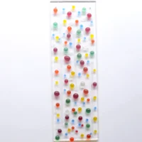 Fused glass suncatcher with multi-colour beads and clear stringers fused on top of a clear piece of glass. Hole at the top with a clear wire threaded through to hang from.