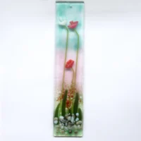Handcrafted long slim fused glass flower suncatcher. Red and white flowers with long green stems, leaves and stones.