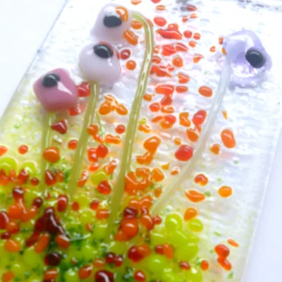 Close up of pink and lilac glass flower suncatcher showing tactile design and detail