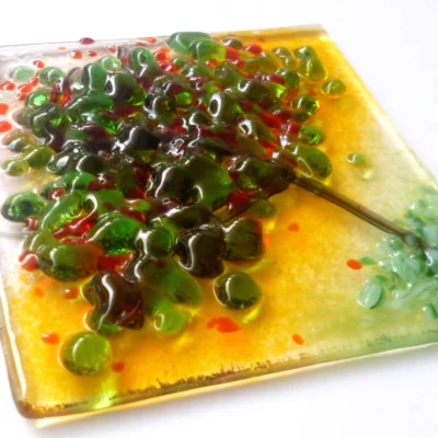 Close up of summer colours fused glass suncatcher showing detail of glass and how tactile it is.
