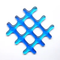 Small two-tone blue lattice fused glass suncatcher. Strips of glass, three in a light blue and three in a darker blue fused in a lattice design, and hangs from a clear wire.